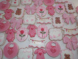 23sweets.com Collection of decorative pink and white cookies shaped like baby-themed items on a white background