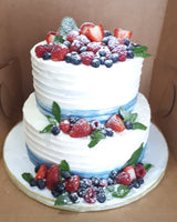 CYNTHIA’s WEDDING CAKE, 2 tier cake with custard filling and topped with fresh fruit.