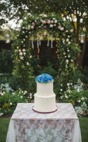 2 tier wedding cake with roses on top