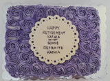 Purple frosted cake with a decorative label on a white background