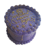 Purple cake with gold text and decorations on a wooden stand., by 23sweets.com