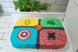 Superhero-themed birthday cake with visible logos on a white background