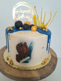 Custom masculine themed 8 inch round cake, fondant motifs cake, with topper